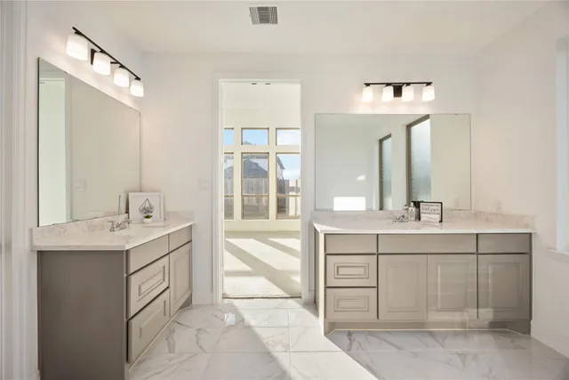 a bathroom with a sink double vanity and a mirror
