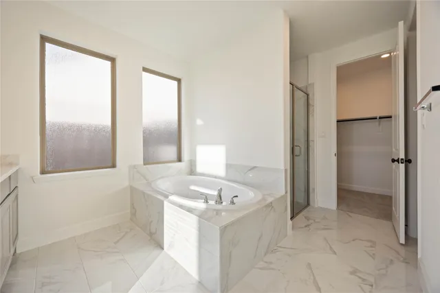 a bathroom with a tub a sink and a mirror