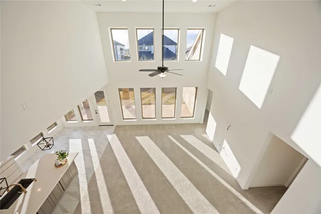 a view of a bedroom with wooden floor and windows