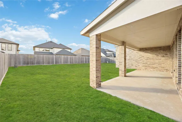 a view of a house with a yard and pathway