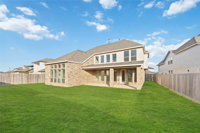 a view of a house with a yard and sitting area