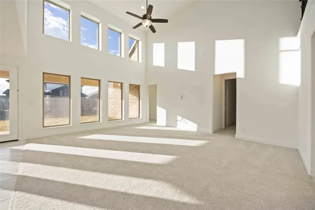 a view of a living room with a ceiling fan and a rug