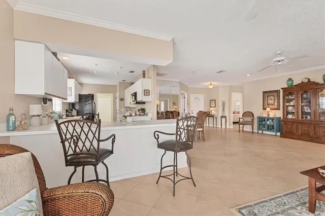 a kitchen with a sink dining table and chairs
