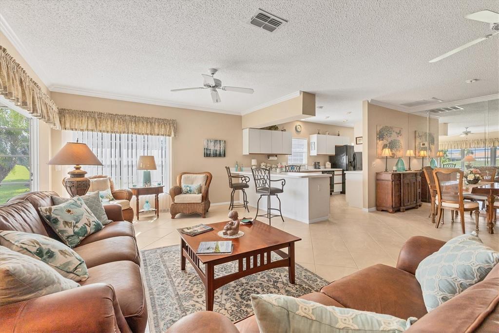 1412 Colony Place Venice, FL 34292 - Photo 12 of 55 a living room with furniture kitchen view and a large window