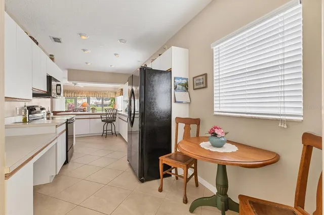a kitchen with stainless steel appliances a refrigerator sink and cabinets