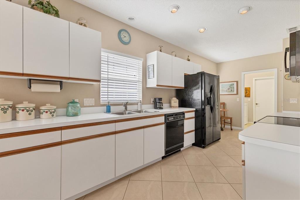 1412 Colony Place Venice, FL 34292 - Photo 16 of 55 a kitchen with stainless steel appliances a refrigerator sink and cabinets