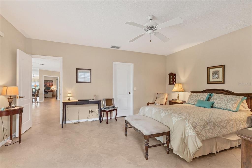1412 Colony Place Venice, FL 34292 - Photo 23 of 55 a spacious bedroom with a bed and a table