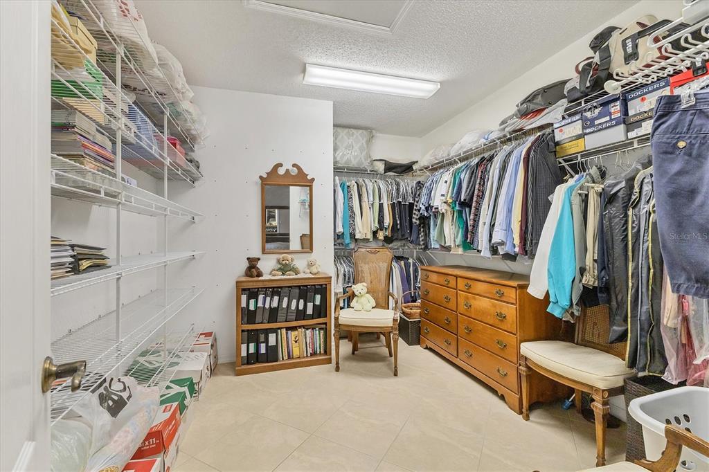 1412 Colony Place Venice, FL 34292 - Photo 24 of 55 a view of walk in closet with clothes and shoes