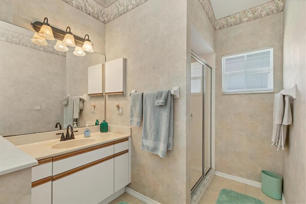 1412 Colony Place Venice, FL 34292 - Photo 26 of 55 a bathroom with a double vanity sink mirror and shower