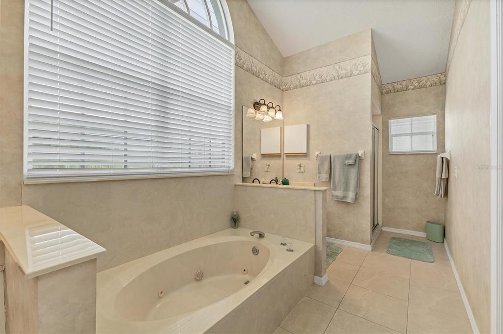 1412 Colony Place Venice, FL 34292 - Photo 27 of 55 a bathroom with a bathtub and a shower