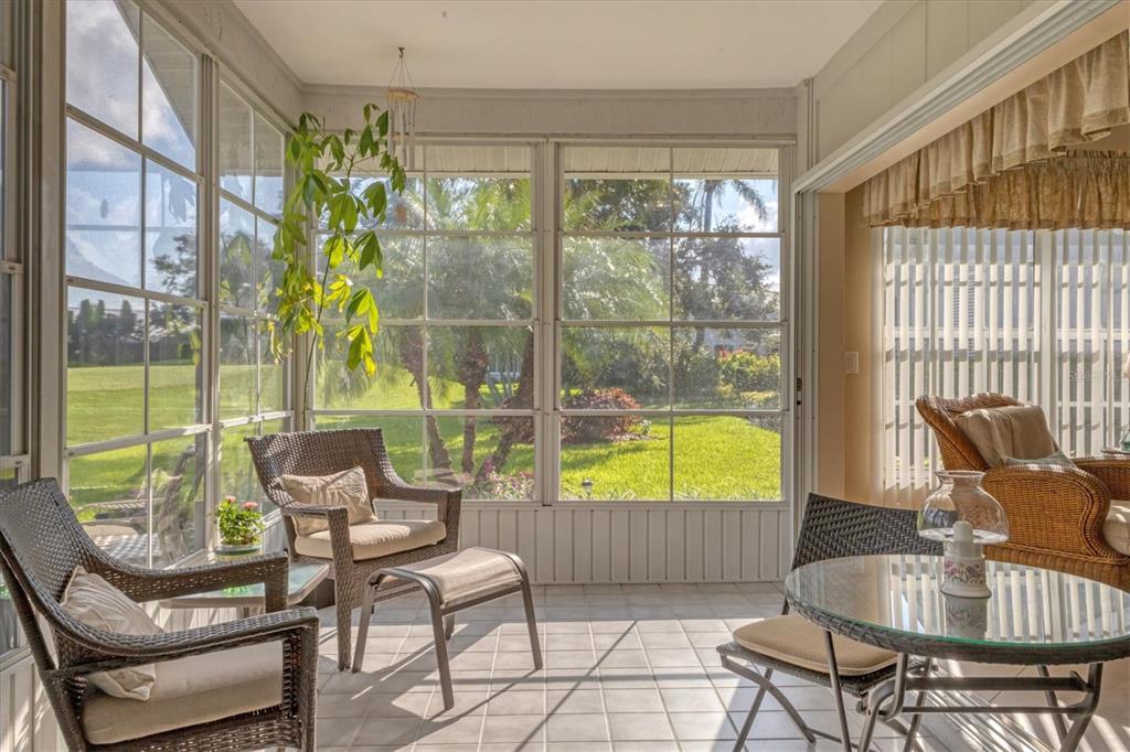 1412 Colony Place Venice, FL 34292 - Photo 33 of 55 a living room with furniture and a floor to ceiling window