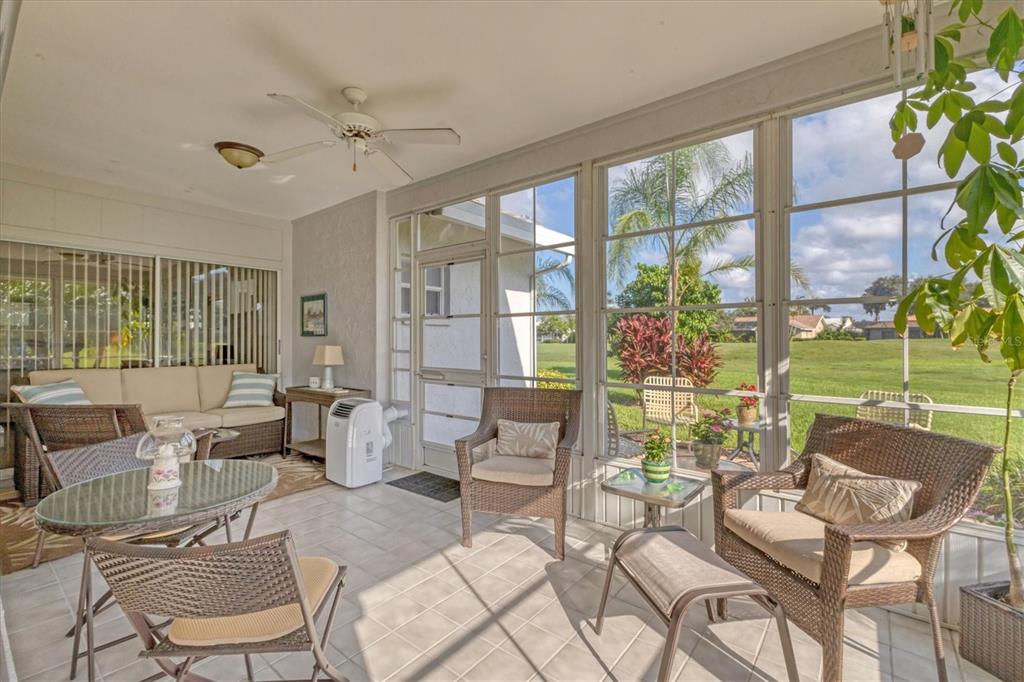 1412 Colony Place Venice, FL 34292 - Photo 35 of 55 a living room with patio furniture and a floor to ceiling window