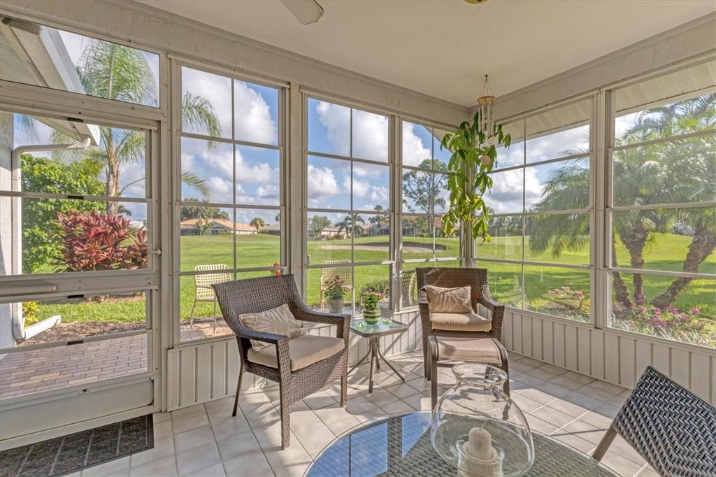 1412 Colony Place Venice, FL 34292 - Photo 36 of 55 a living room with large windows and wooden floor