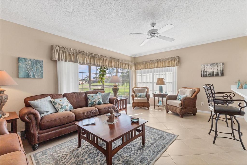 1412 Colony Place Venice, FL 34292 - Photo 7 of 55 a living room with furniture and a large window