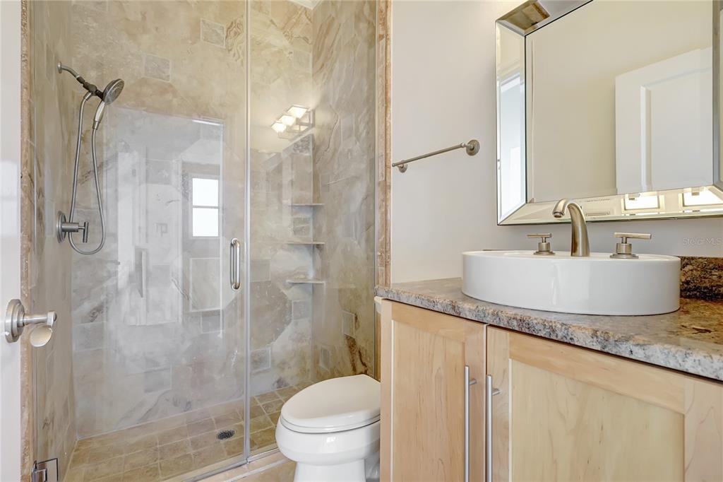 2863 Duncan Tree Circle Valrico, FL 33594 - Photo 32 of 53 a bathroom with a granite countertop sink toilet and shower