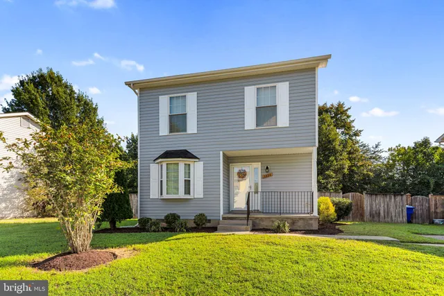a house view with swimming pool and garden space