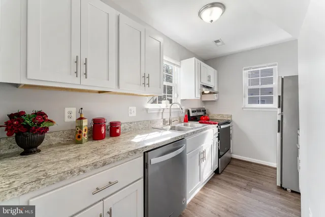 a kitchen with a refrigerator stove and sink