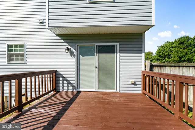 a view of a house with a backyard and a deck