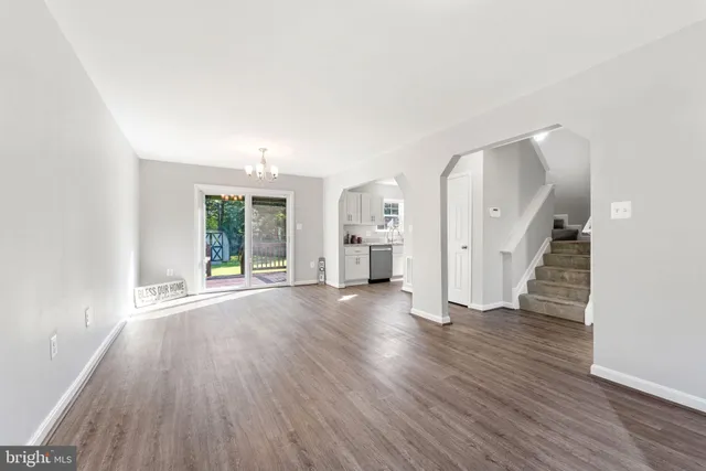 an empty room with window and wooden floor