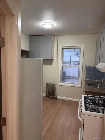 a kitchen with a refrigerator and a stove top oven