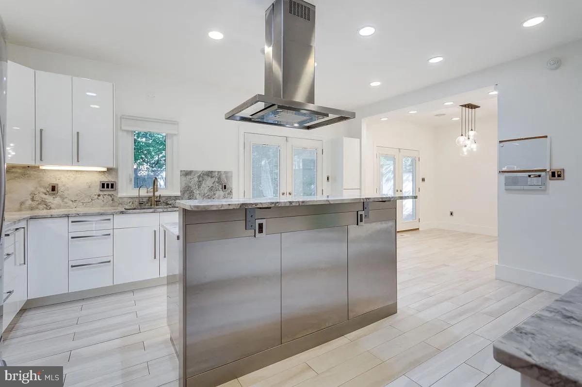 4611 Charleston Terrace Northwest Washington, DC 20007 - Photo 17 of 55 a kitchen with kitchen island granite countertop stainless steel appliances lots of counter top space cabinets and a sink