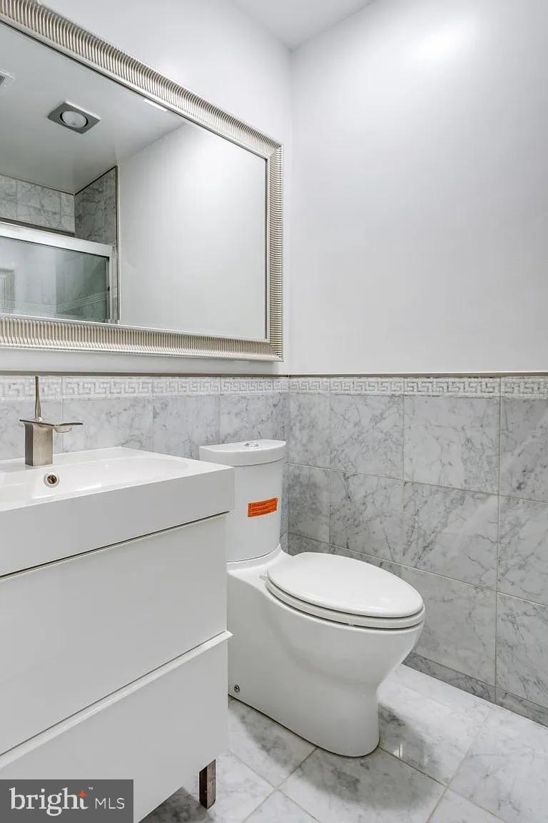 4611 Charleston Terrace Northwest Washington, DC 20007 - Photo 20 of 55 a bathroom with a toilet sink and mirror