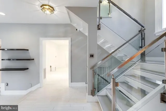 a view of entryway and hall with wooden floor