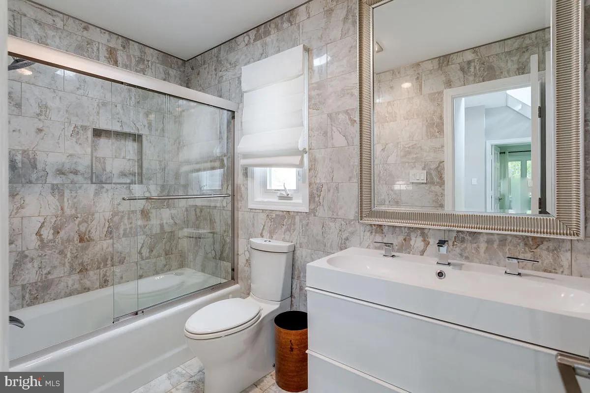 4611 Charleston Terrace Northwest Washington, DC 20007 - Photo 27 of 55 a bathroom with a sink toilet and shower