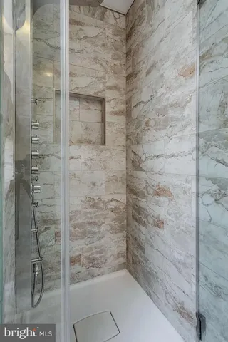 a bathroom with a double vanity sink mirror double and shower