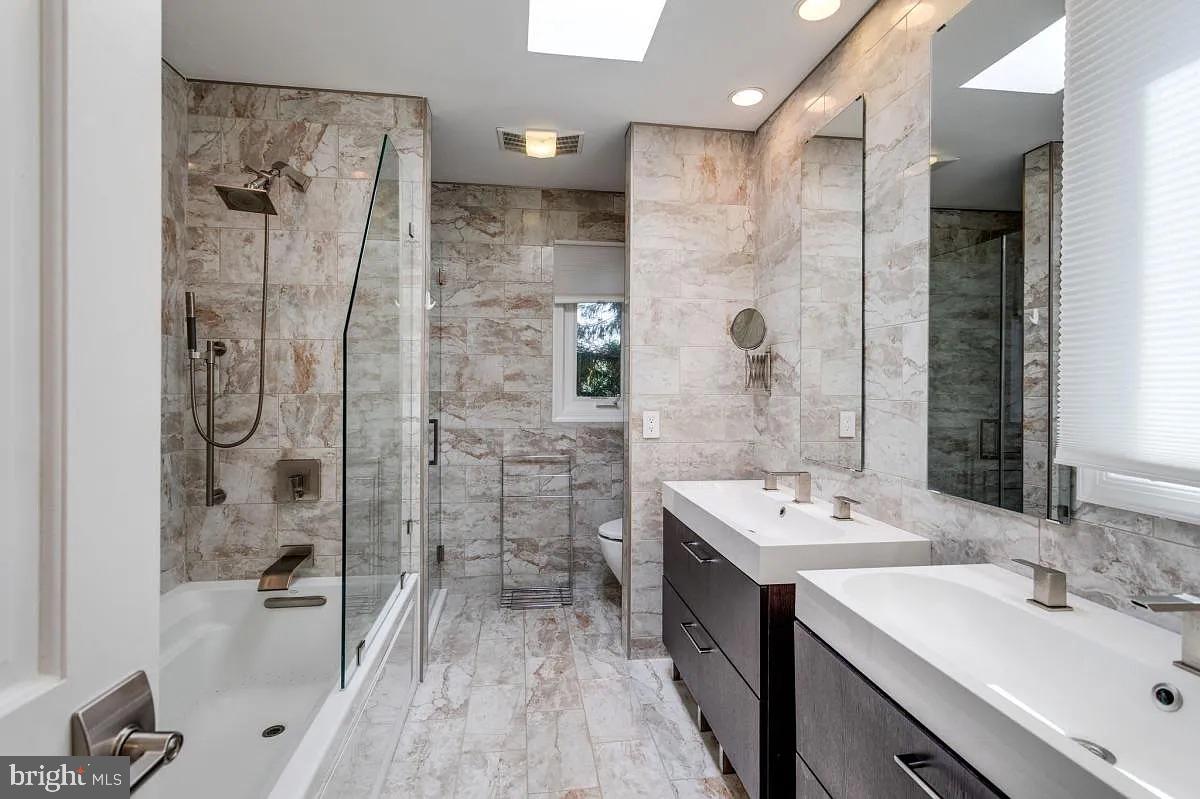 4611 Charleston Terrace Northwest Washington, DC 20007 - Photo 34 of 55 a bathroom with a double vanity sink mirror double and shower