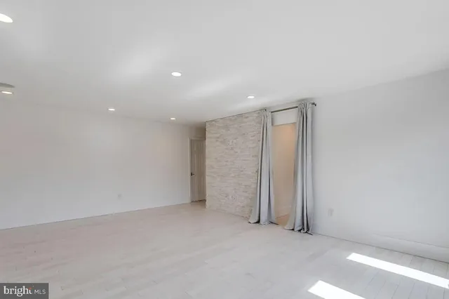 a view of an empty room with glass door