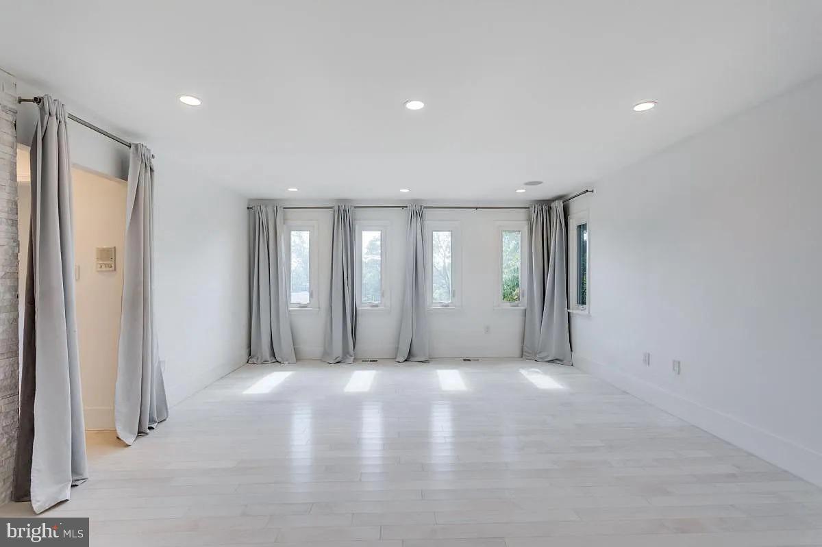 4611 Charleston Terrace Northwest Washington, DC 20007 - Photo 37 of 55 a view of an empty room with wooden floor and windows
