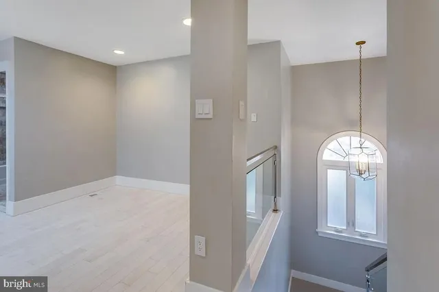 a room with a large window and a chandelier