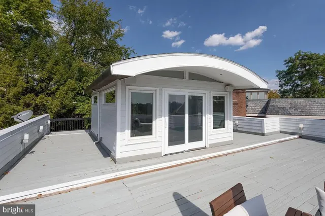 a front view of a house with trees