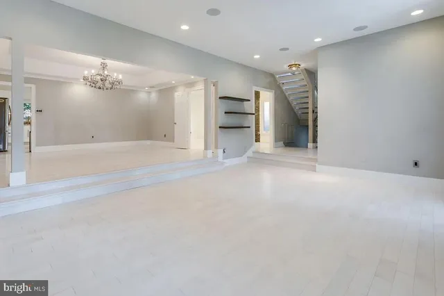 an empty room with a cabinet and mirrors