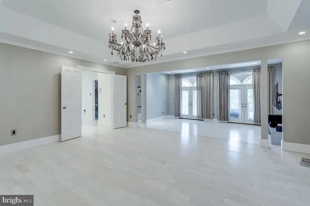 a view of an empty room with a chandelier