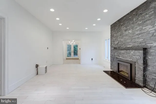 a view of empty room with a fireplace