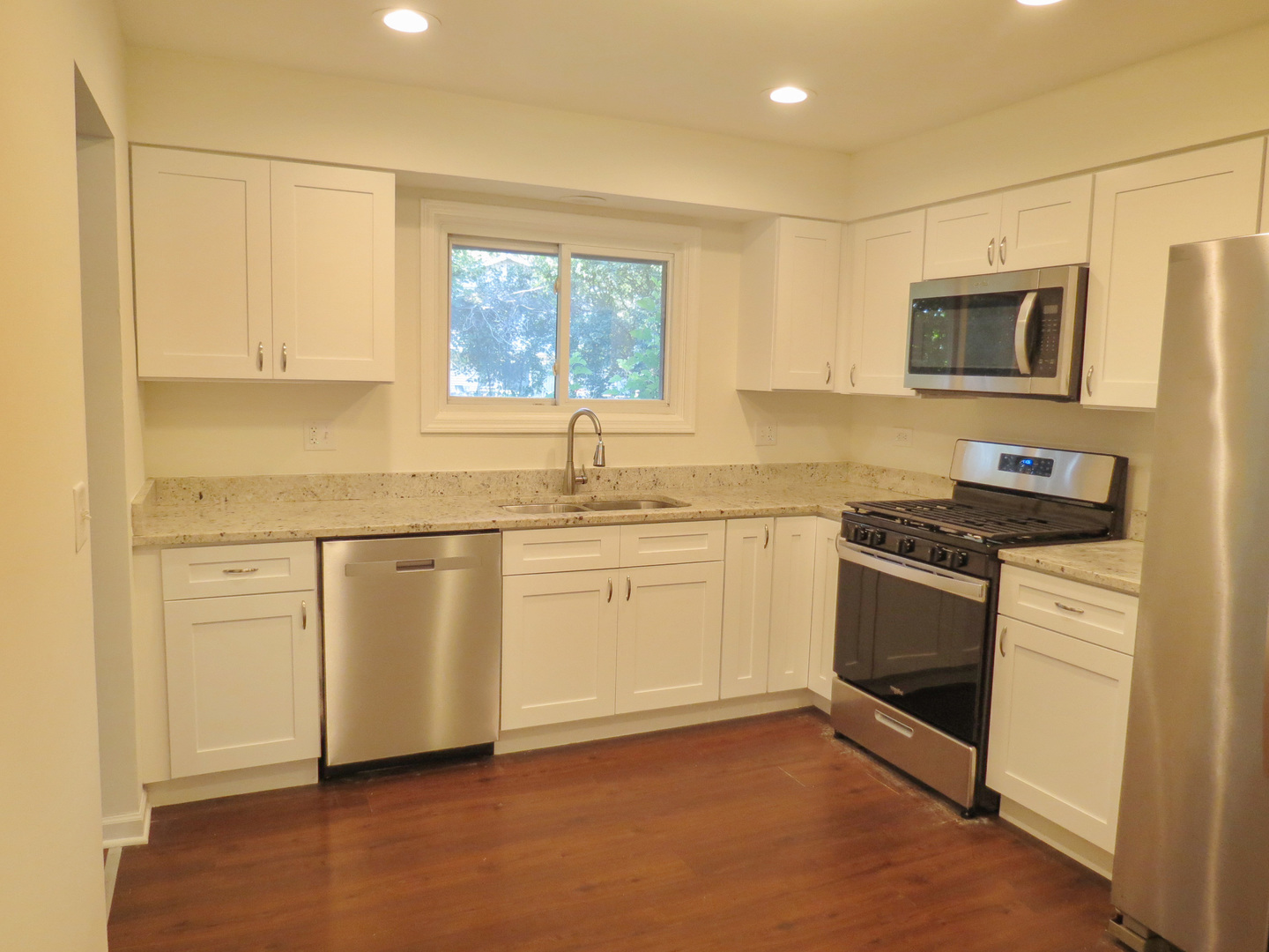 231 Charlotte Lane Bolingbrook, IL 60440 - Photo 12 of 37 a kitchen with granite countertop cabinets stainless steel appliances and a sink