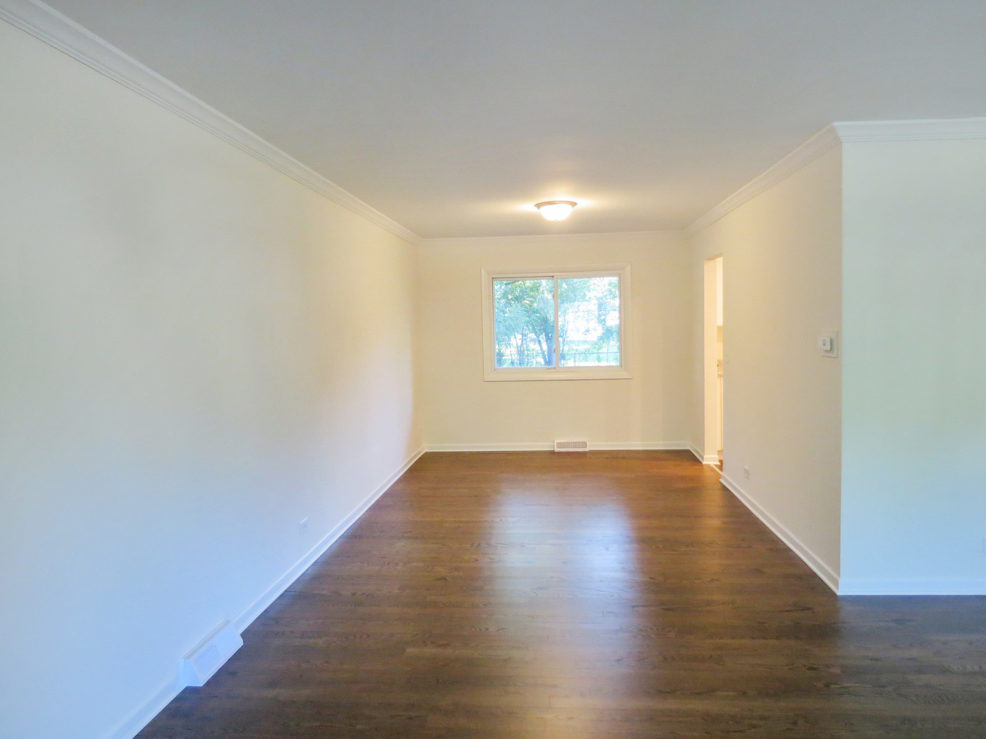 231 Charlotte Lane Bolingbrook, IL 60440 - Photo 6 of 37 an empty room with wooden floor and windows