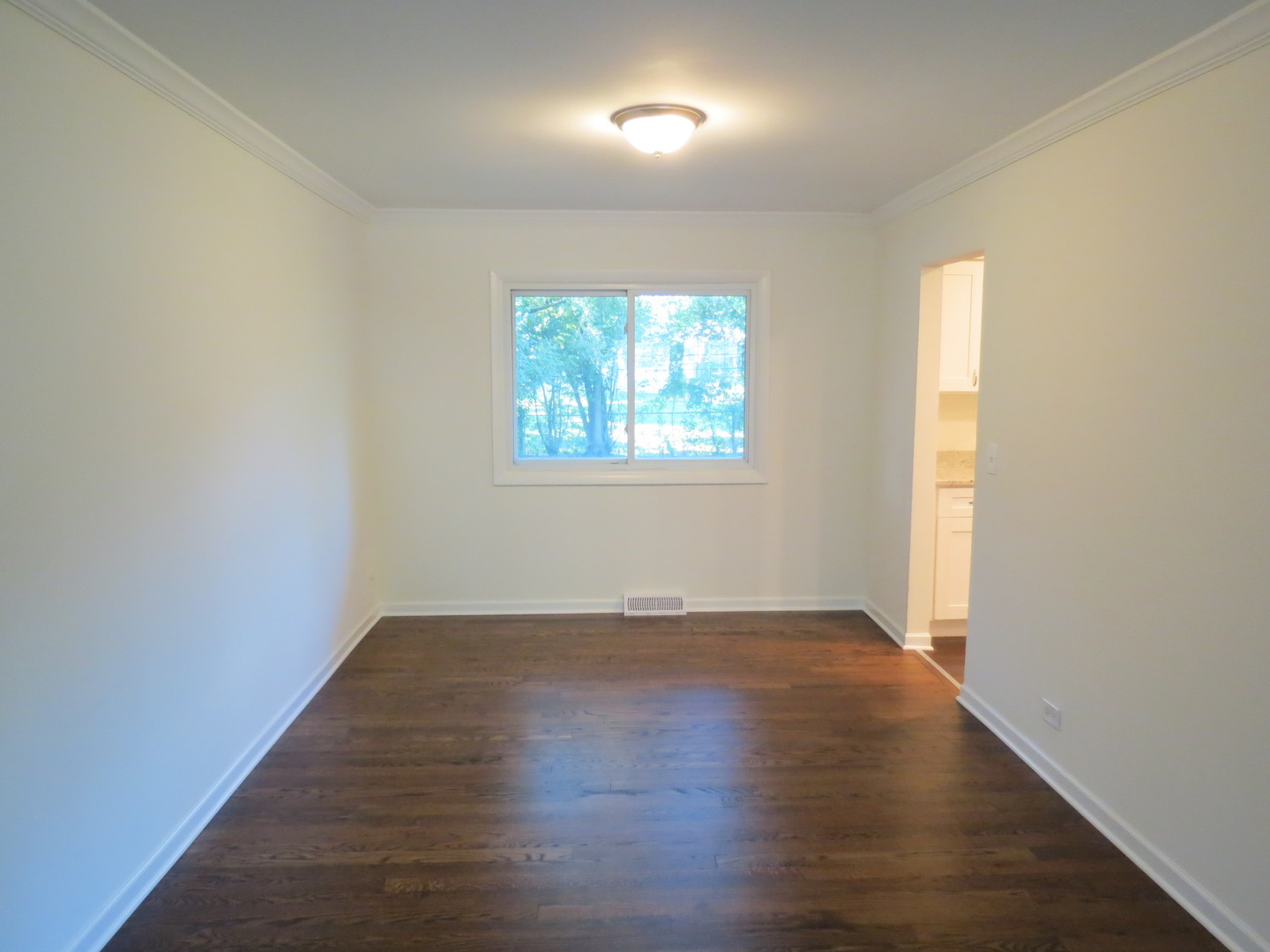231 Charlotte Lane Bolingbrook, IL 60440 - Photo 8 of 37 an empty room with wooden floor and windows