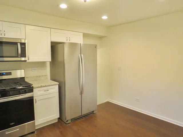 a kitchen with a refrigerator stove and microwave