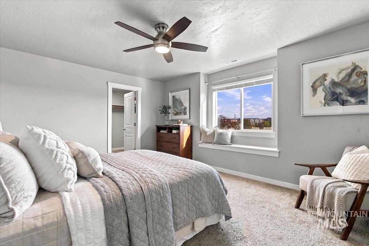 124 South Sunset Point Way Meridian, ID 83642 - Photo 19 of 24 Carpet flooring, neutral painted walls, window with natural light, and a flush mount ceiling light fixture