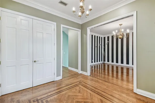 a view of a livingroom with wooden floor and stairs