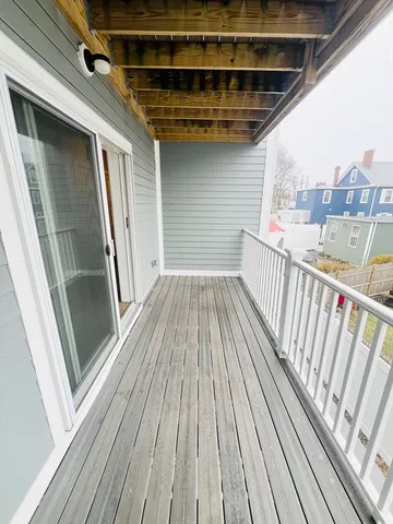 a view of a balcony with wooden floor