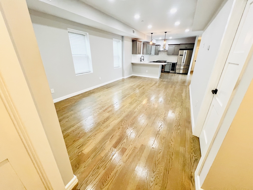 47-49 Walnut Street, Unit 2 Boston, MA 02122 - Photo 3 of 12 a view of empty room with wooden floor
