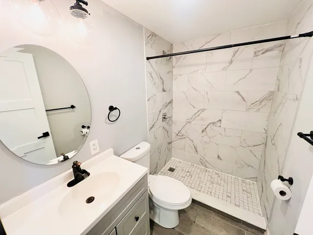 a bathroom with a sink toilet and shower