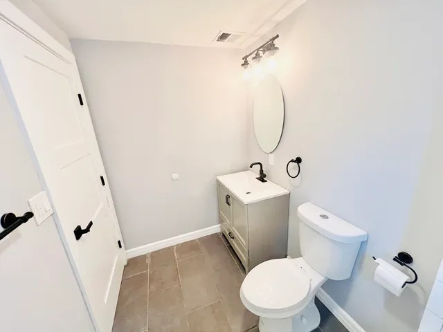 a white toilet sitting next to a bathroom sink