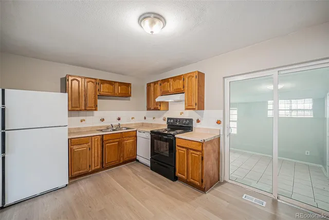a kitchen with a sink a stove and refrigerator