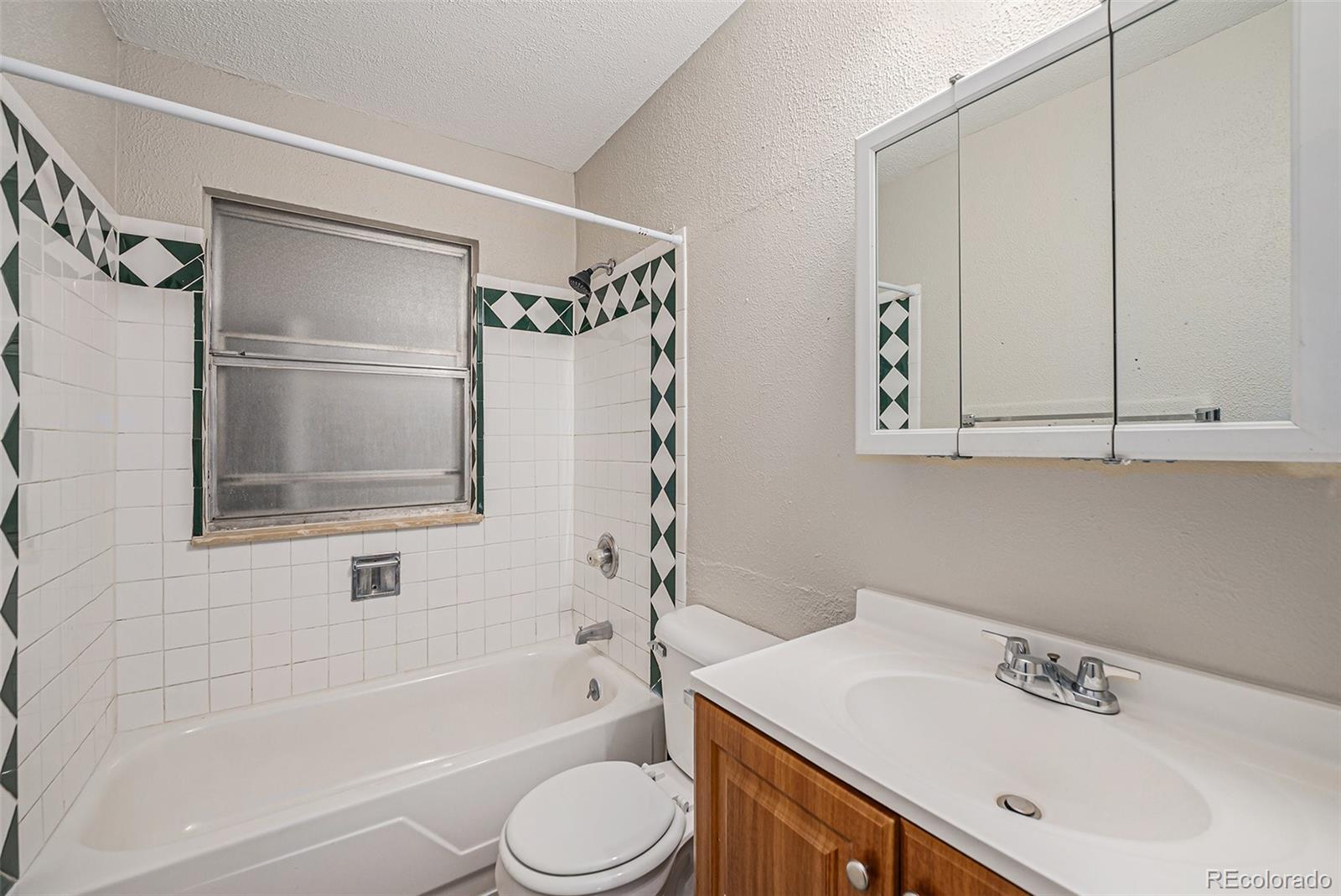 13192 Maxwell Place Denver, CO 80239 - Photo 6 of 10 a bathroom with a sink a toilet and shower