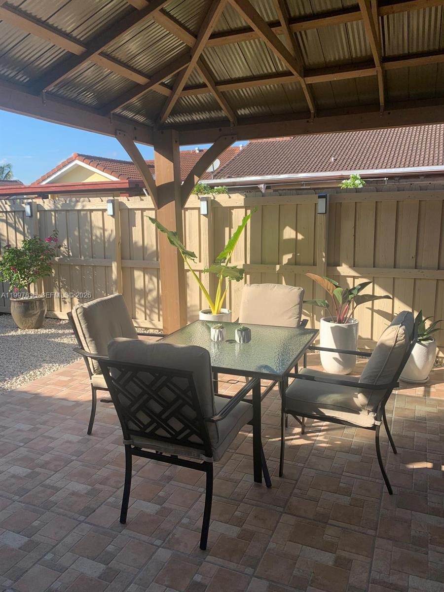 4533 Southwest 143rd Place Miami, FL 33175 - Photo 12 of 12 a view of a table and chairs in patio